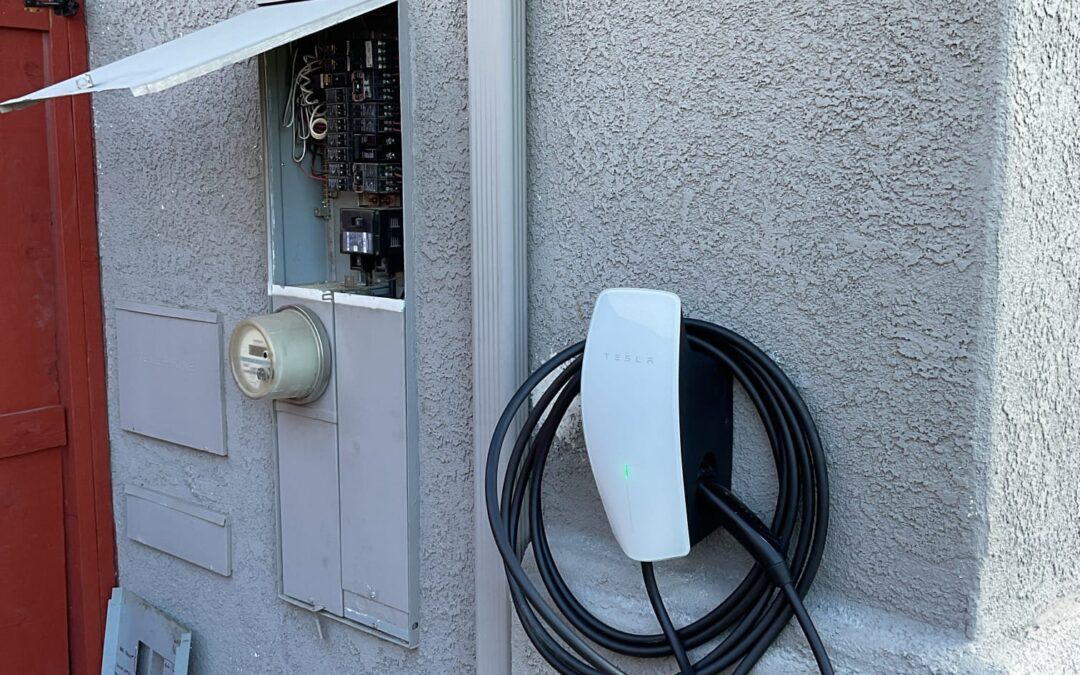 Tesla EV Charger Station Installed on the side of a home in san diego near the electrical panel